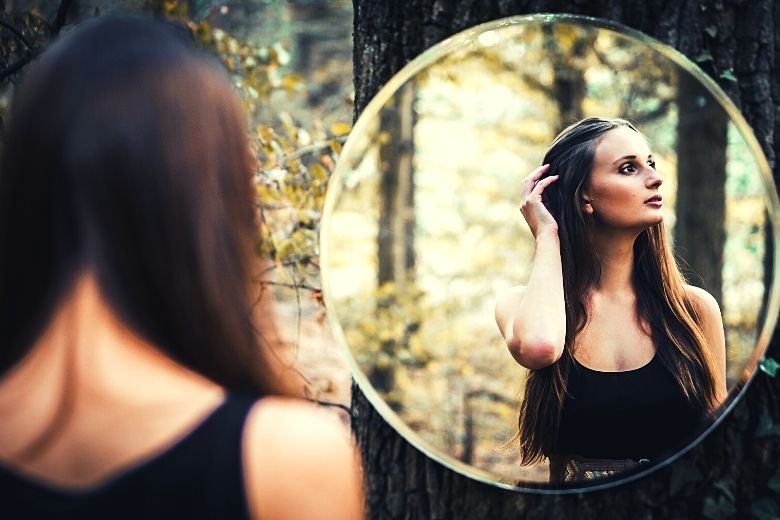 Woman looking in mirror